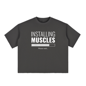 Black t-shirt with white text 'Installing Muscles' on a white background